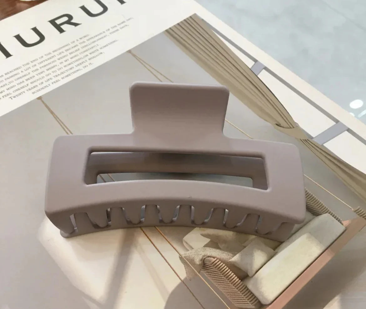 Gray hair clip on a magazine with blurred background