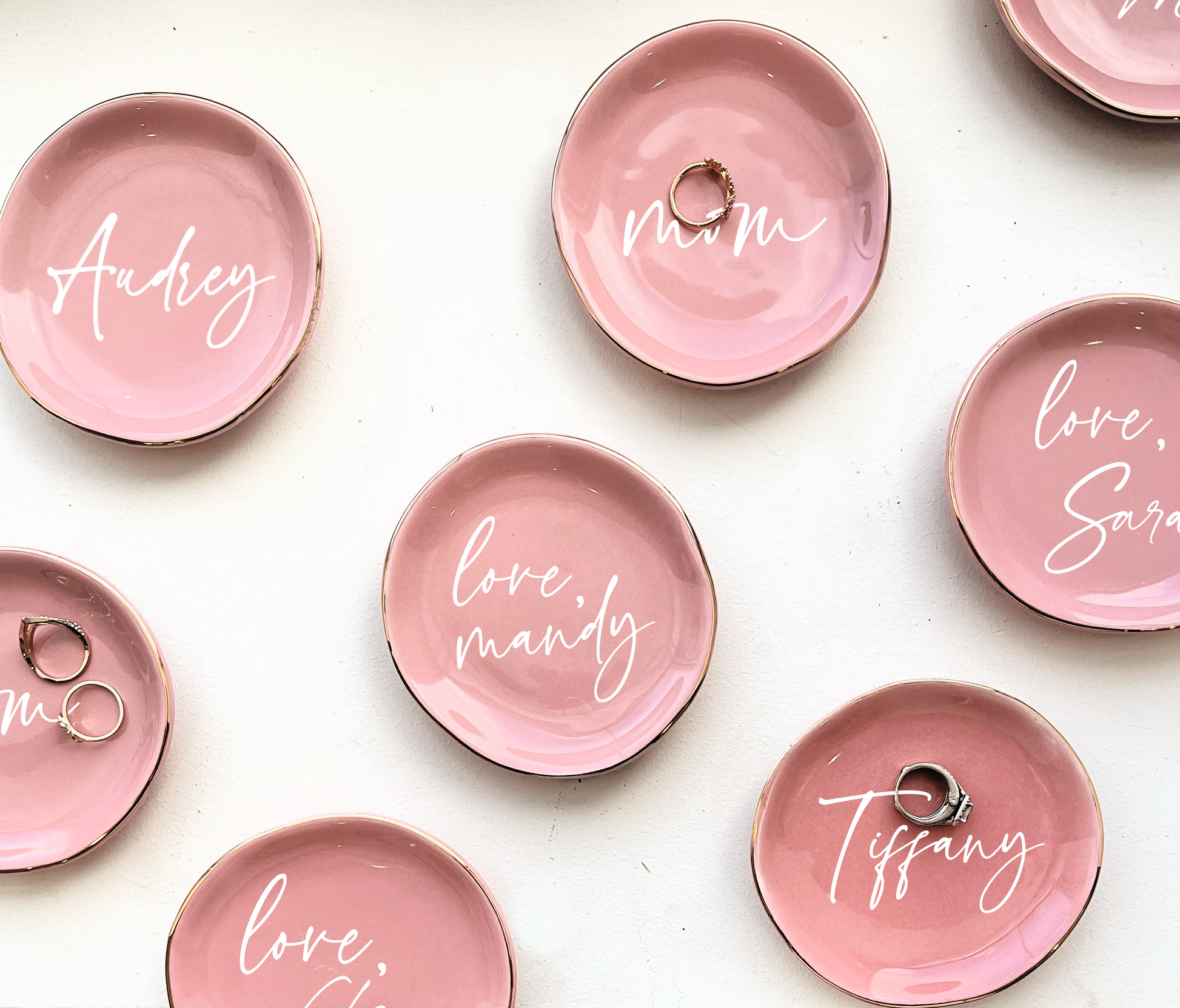 Pink personalized ring dishes on a white background