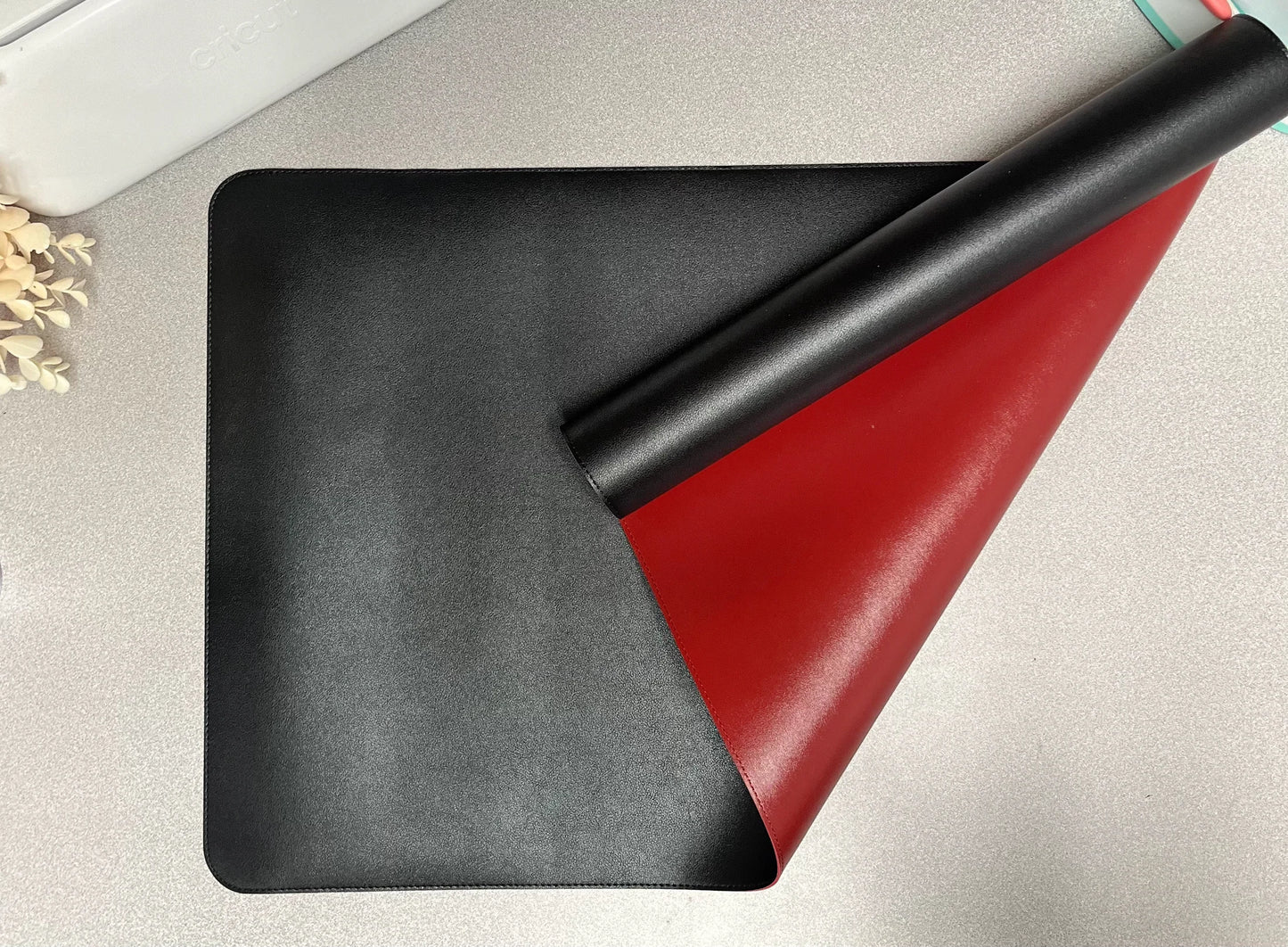 Black and red leather wallet on a light gray surface