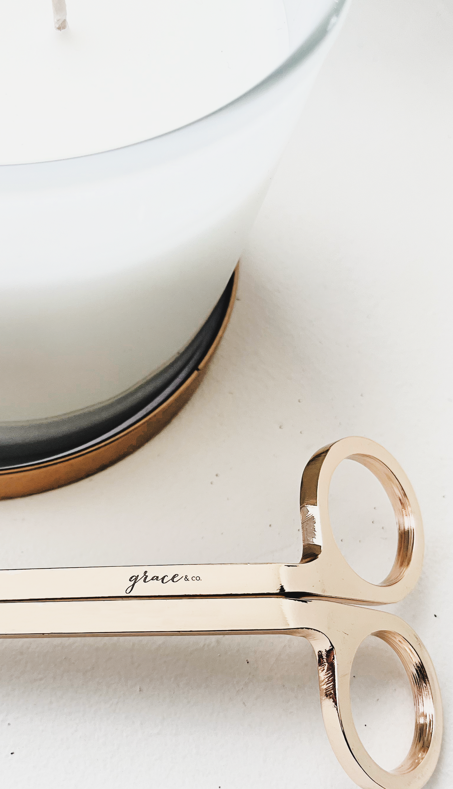 Rose gold scissors with 'grace' engraved on a white surface