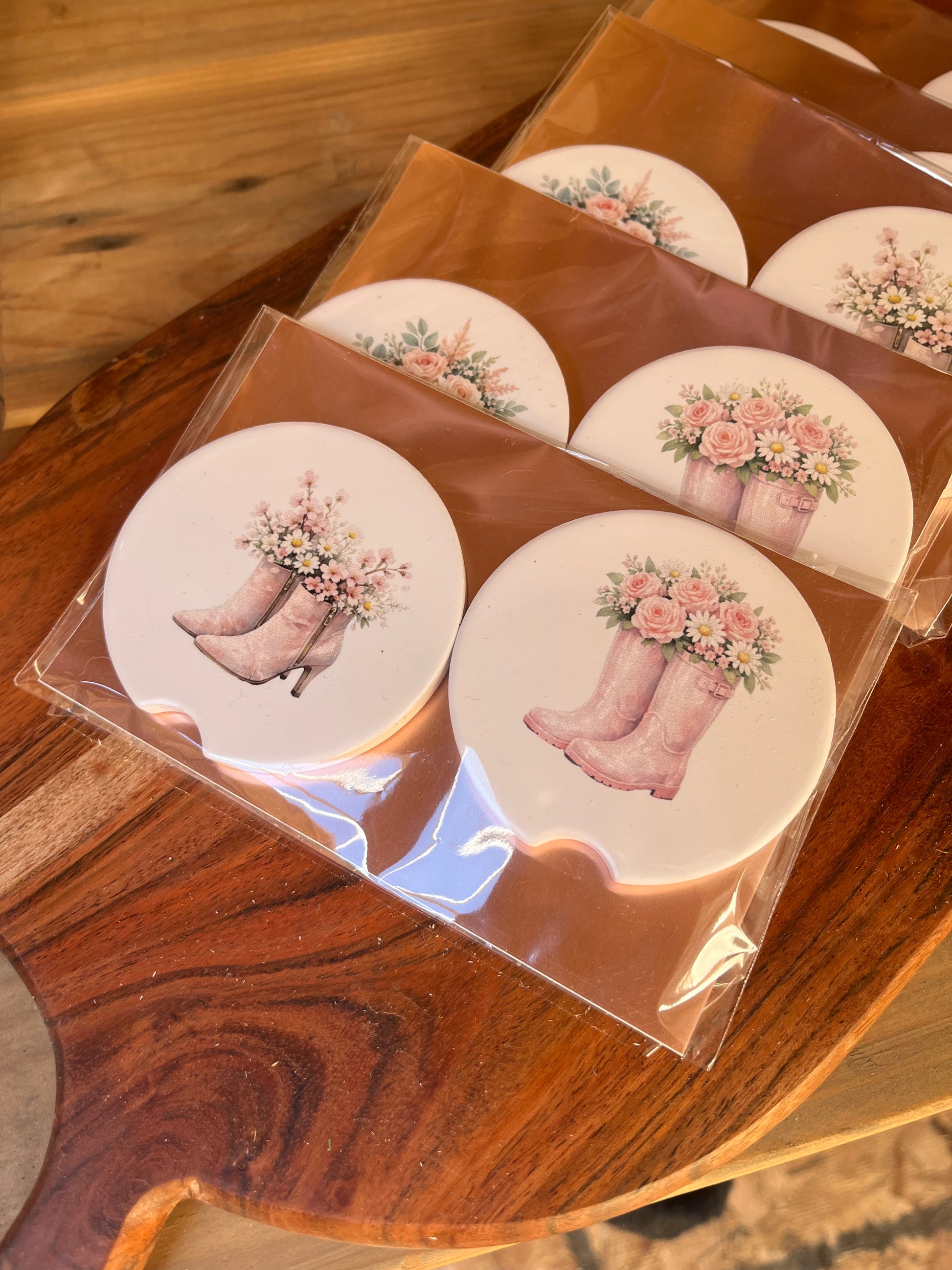 car coasters in on pink cardstock on wood background