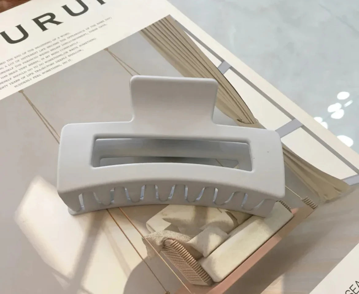 White hair clip on a magazine page